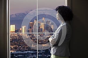 Businesswoman in Los Angeles Looking at Office Window