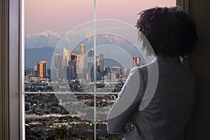 Businesswoman in Los Angeles Looking at Office Window