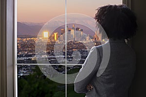 Businesswoman in Los Angeles Looking at Office Window