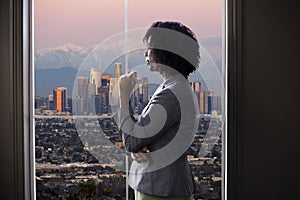 Businesswoman in Los Angeles Looking at Office Window