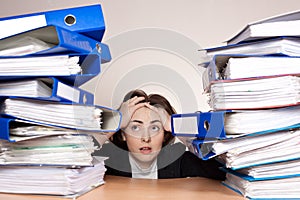 Businesswoman with a lot of folders on the table