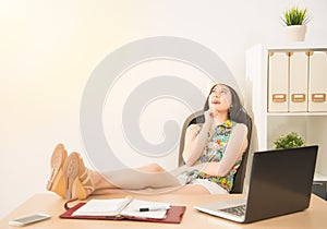 Businesswoman lying down on chair daydream