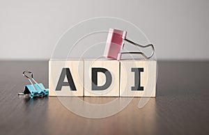 Businesswoman made word adi with wood building blocks