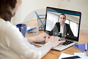 Businesswoman making video call to business partner using laptop