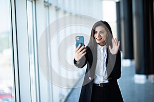 Businesswoman making video call to business partner using laptop, looking at screen with virtual web chat, contacting client by