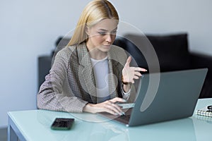 Businesswoman making video call to business partner using laptop. Young woman having discussion with corporate client. Remote job