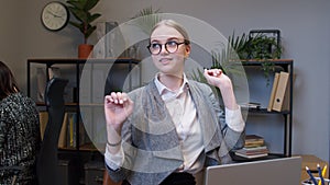 Businesswoman manager working on laptop at desk, dancing, celebrate victory achieved good job result