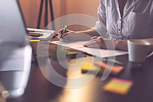 Businesswoman marking segments of a contract with a highlighter