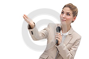 Businesswoman with microphone pointing at something