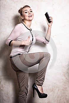 Businesswoman with mobile phone showing thumb up