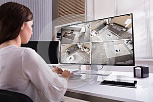Businesswoman Monitoring CCTV Footage On Computer