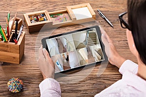 Businesswoman Monitoring The CCTV Footage On Digital Tablet