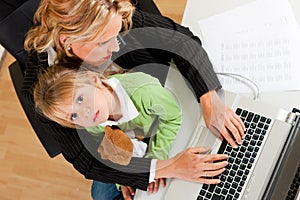 Businesswoman and mother is working at home photo