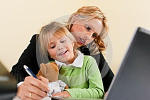 Businesswoman and mother is working at home photo