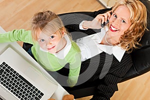 Businesswoman and mother is working in the interne photo