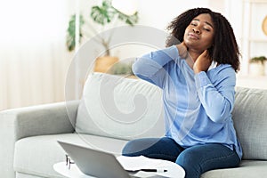 Businesswoman with neck pain after long hours at work