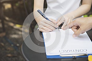 A businesswoman is negotiating a business deal or contracting