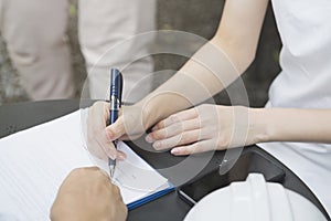 A businesswoman is negotiating a business deal or contracting photo