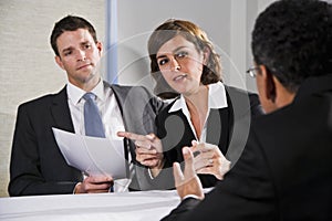 Businesswoman negotiating with men