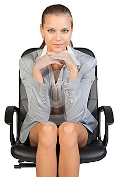 Businesswoman on office chair, with head reclined