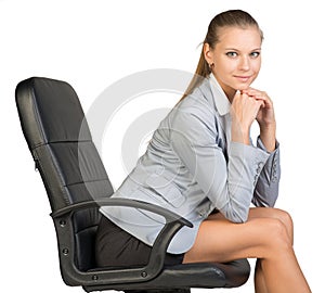 Businesswoman on office chair, with head reclined