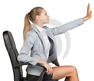 Businesswoman on office chair, with her hand