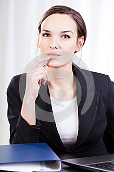 Businesswoman in an office contemplateing