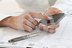 Businesswoman in office noting an appointment photo