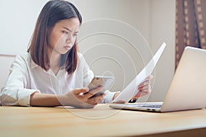 Businesswoman in office and use computer to perform financial accounting.