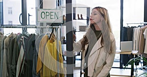 Businesswoman, open sign and window at store for service, small business and entrepreneur. Creative female person, owner