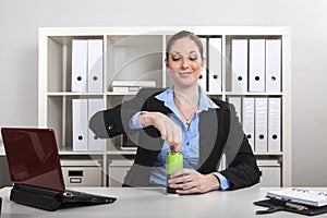 Businesswoman opens beverage can