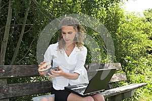 Businesswoman in the park; healthy lunch