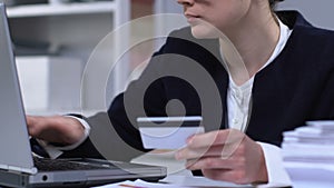 Businesswoman paying bills online using credit card, paid registration, closeup