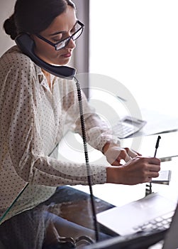 Businesswoman, phone call and notes, office and desk or conversation with client. Technology, computer and writing