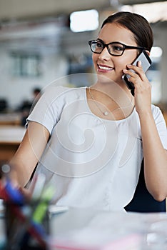 Businesswoman, phone call and smile at desk in office for talking, networking and discussion. Happiness, communication