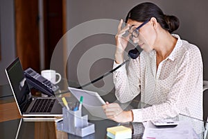 Businesswoman, phone call and stressed in office, desk and on landline with client. Technology, computer and tablet