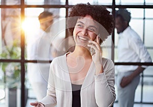 Businesswoman with phone in modern office photo