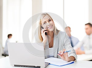 Businesswoman with phone in office