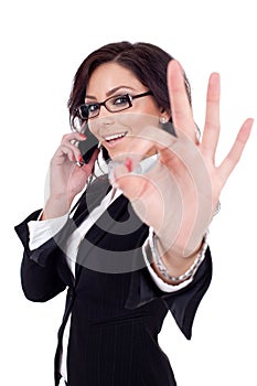 Businesswoman with phone and ok gesture