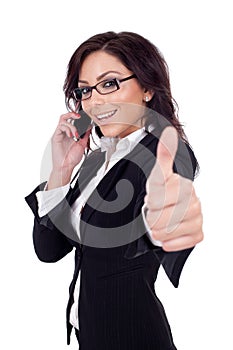 Businesswoman with phone and thumbs up gesture,