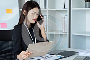 Businesswoman on the phone and using laptop at office. Businesswoman professional talking on mobile phone