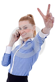 Businesswoman with phone and victory gesture