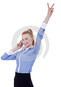 Businesswoman with phone and victory gesture