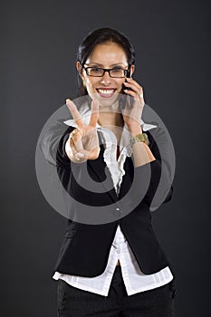 Businesswoman on the phone victory sign