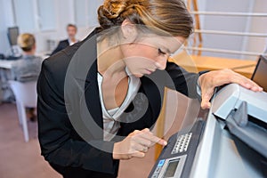 Businesswoman photocopying documents in office