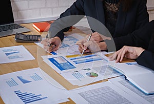 Businesswoman pointing pen on business document at meeting room.Discussion and analysis data charts and graphs showing the results