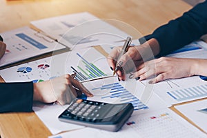 Businesswoman pointing pen on business document at meeting room.Discussion and analysis data charts and graphs showing the results