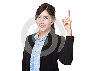 Businesswoman pointing upwards