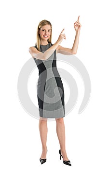 Businesswoman Pointing Upwards Against White Background