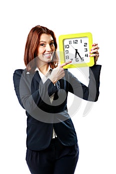 Businesswoman pointing on a wall clock